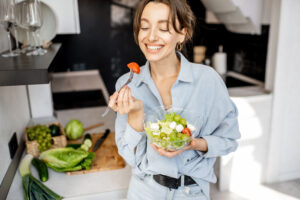 Private Health Rebate represented by health conscious woman happily eating a salad