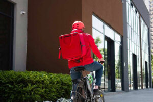 Doordash man riding a bicycle for food delivery service in the share economy