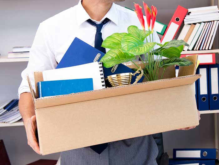 Redundant man carrying box and hoping for a good Employment Termination Payment