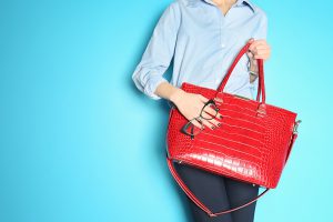 Woman holding handbag to claim as a tax deduction