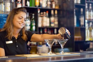 Bartender pouring a drink at the bar