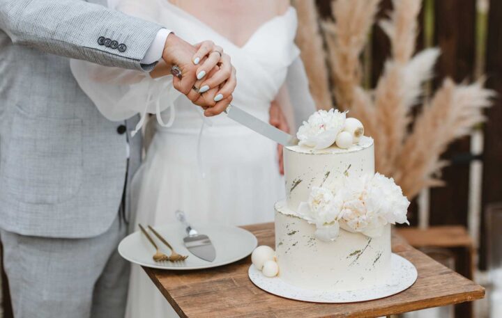 Bride and groom cutting wedding cake