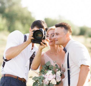 freelancer photographer showing a couple their wedding photos