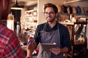 Retail worker accepting payment from a customer