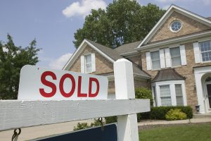 House with a sold sign in the front yard