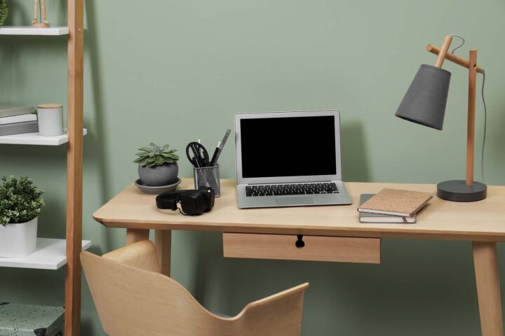 Working from home tax deductions. Image of a home office with computer on desk with stationary.