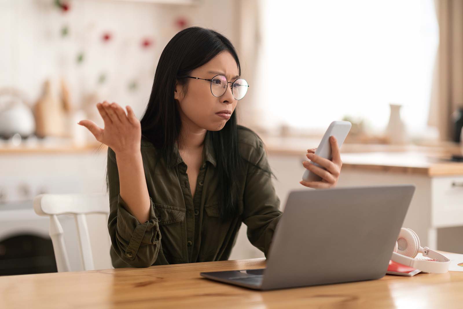 Lady sitting at her laptop disappointed to read the Stage 3 tax cuts won't give her a better refund