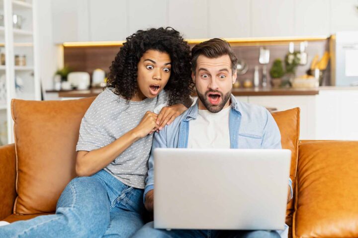 Couple sitting on couch surprised at the changes to the Stage 3 tax cuts