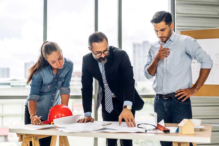 A developer and buyers discussing paying GST at settlement