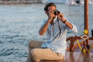 FIRE Movement retiree male taking photographs in Italy