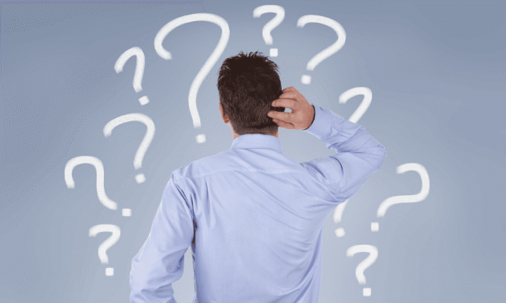 Confused man facing the back surrounded by question marks